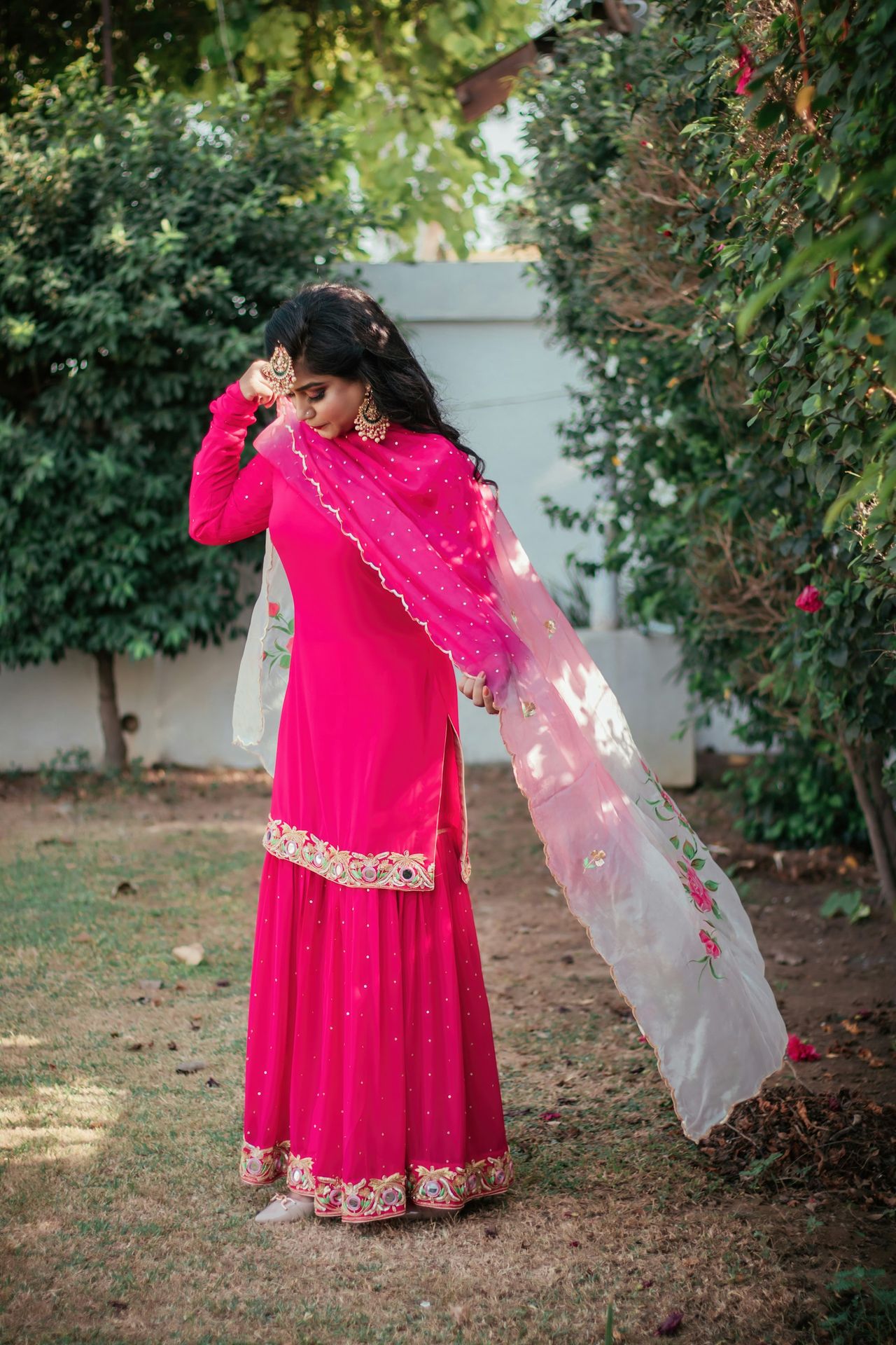 woman in purple long sleeve dress standing on green grass field during daytime